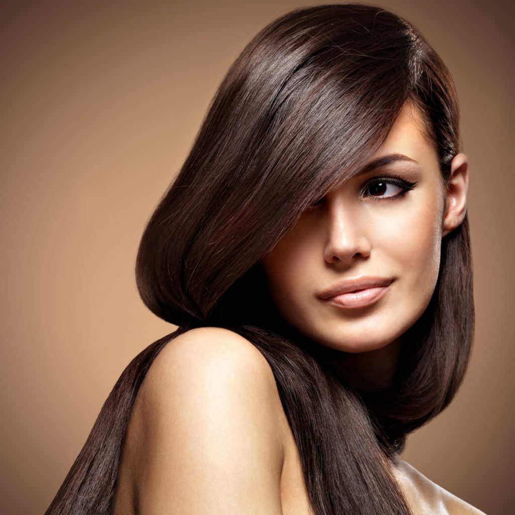 Beautiful young woman with long straight brown hair.