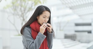 Woman eating japanese rice cake B8NYDJF